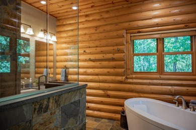 Sweeping lake views in this custom log retreat designed for - photo 15