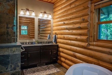 Sweeping lake views in this custom log retreat designed for - photo 16