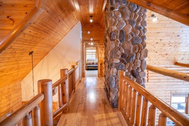 Sweeping lake views in this custom log retreat designed for - photo 23