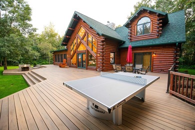 Sweeping lake views in this custom log retreat designed for - photo 39