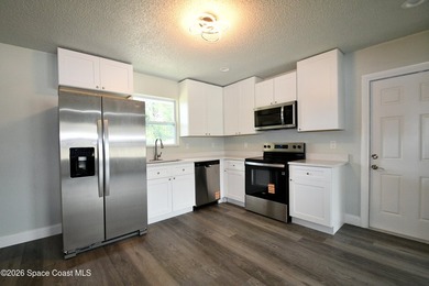 This updated Palm Bay home is set just off a main road, making - photo 4