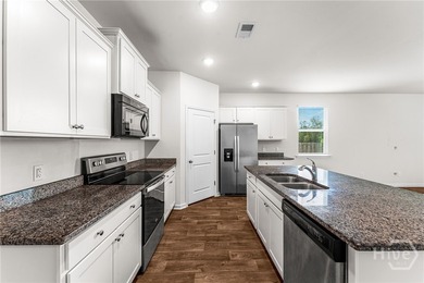 Welcome to this beautiful 4-bedroom, 2-bath home featuring an - photo 19