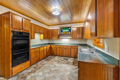 Hidden beneath towering hardwoods on a private wooded setting - photo 12
