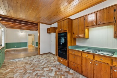Hidden beneath towering hardwoods on a private wooded setting - photo 13