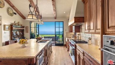 Tucked away behind gates atop the Malibu hills, this enchanting - photo 18
