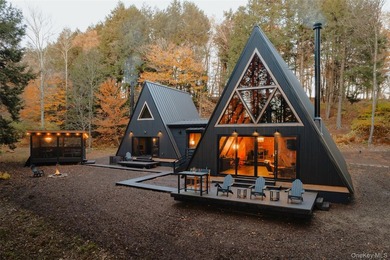 Escape to your own private woodland getaway in this striking - photo 1
