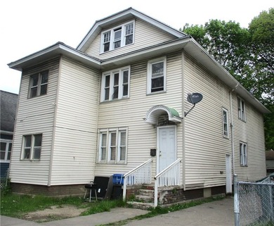 This vinyl-sided multi-family home has two 3-bedroom units. Each - photo 2
