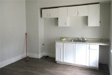 This vinyl-sided multi-family home has two 3-bedroom units. Each - photo 3