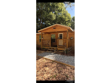 This charming log cabin-style cottage offers the perfect blend - photo 3
