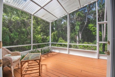 Tucked beneath a canopy of mature trees in the gated community - photo 11
