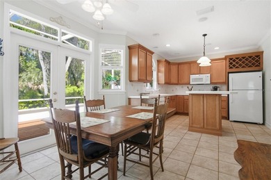 Tucked beneath a canopy of mature trees in the gated community - photo 13