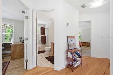 Tucked beneath a canopy of mature trees in the gated community - photo 32