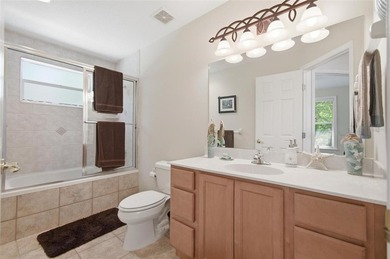 Tucked beneath a canopy of mature trees in the gated community - photo 35