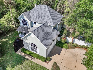 Tucked beneath a canopy of mature trees in the gated community - photo 44