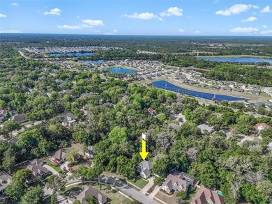 Tucked beneath a canopy of mature trees in the gated community - photo 47