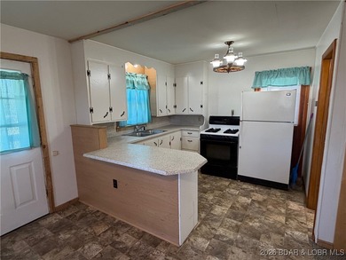 Cute as a button! This cozy cabin is perfectly positioned on a