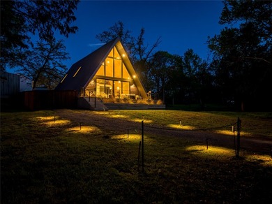 Elevated open water views pair with lake access at this A-frame - photo 2