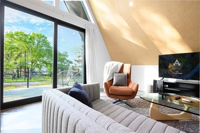 Elevated open water views pair with lake access at this A-frame - photo 7