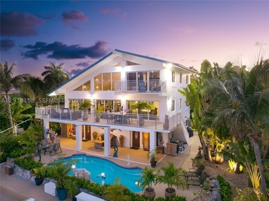 A rare waterfront estate along a 200-foot wide canal with a - photo 12