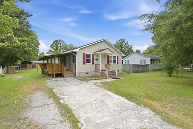 This three-bedroom, one-and-a-half-bath home is situated on a - photo 3