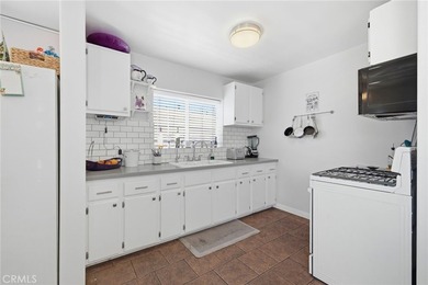 Nestled on a quiet tree lined street in North Long Beach, this - photo 16