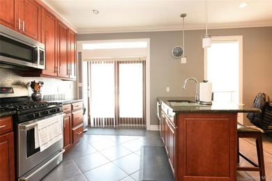 Welcome to this beautifully maintained brick two-family home in - photo 2