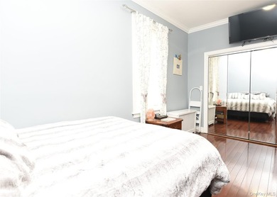 Welcome to this beautifully maintained brick two-family home in - photo 8
