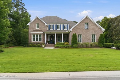 This elegant brick home is ideally situated on a quiet - photo 1