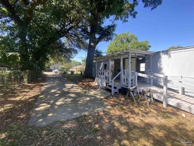 This corner lot property includes a mobile home featuring 2 - photo 3