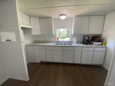 This corner lot property includes a mobile home featuring 2 - photo 8