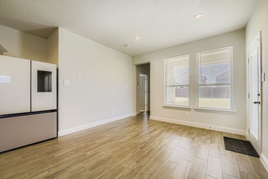 This like new, barely lived in smart home, features an open - photo 12