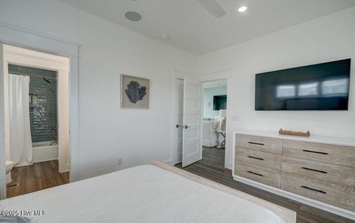 Nestled along a pristine stretch of coastline, this stunning