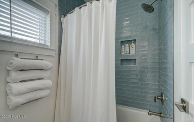 Nestled along a pristine stretch of coastline, this stunning