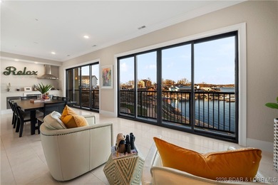 Experience refined lake living in this walk-in level, end-unit