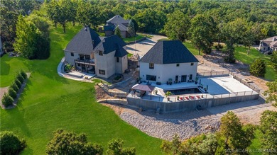 Welcome to a one-of-a-kind luxury estate in a gated Osage Beach