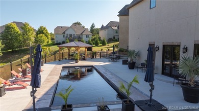 Welcome to a one-of-a-kind luxury estate in a gated Osage Beach