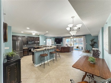 Welcome to Majestic Pointe Unit 1A, a rare end-unit in a gated