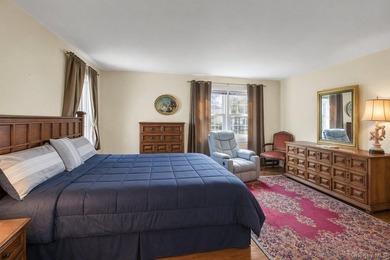 This Munsey Park brick split-level home is situated on a - photo 11