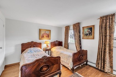 This Munsey Park brick split-level home is situated on a - photo 16
