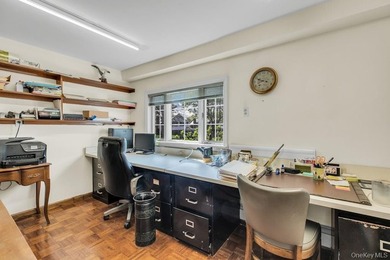 This Munsey Park brick split-level home is situated on a - photo 19