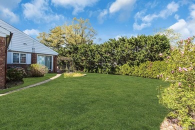 This Munsey Park brick split-level home is situated on a - photo 20