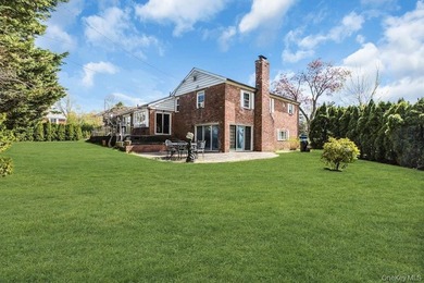 This Munsey Park brick split-level home is situated on a - photo 21