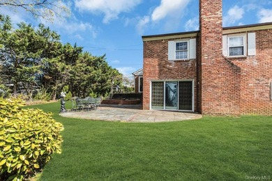 This Munsey Park brick split-level home is situated on a - photo 22