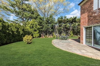 This Munsey Park brick split-level home is situated on a - photo 23
