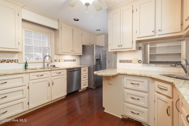 This charming brick ranch stands out on its corner lot within