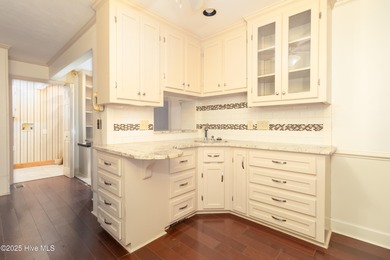 This charming brick ranch stands out on its corner lot within