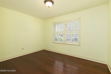 This charming brick ranch stands out on its corner lot within