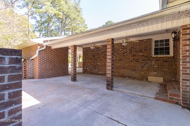This charming brick ranch stands out on its corner lot within
