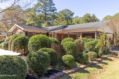 This charming brick ranch stands out on its corner lot within
