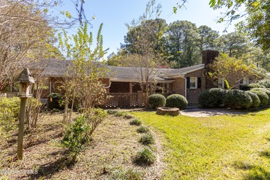 This charming brick ranch stands out on its corner lot within